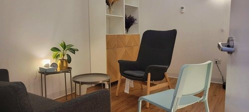 Office interior with plant, couch, and chairs