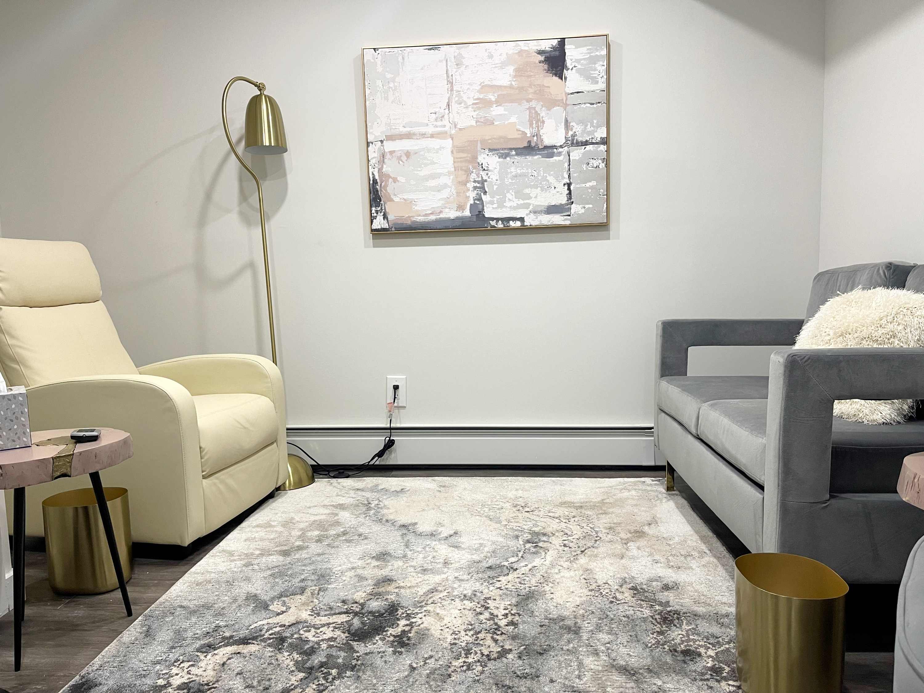 Cozy living room area with couch, chair, and rug