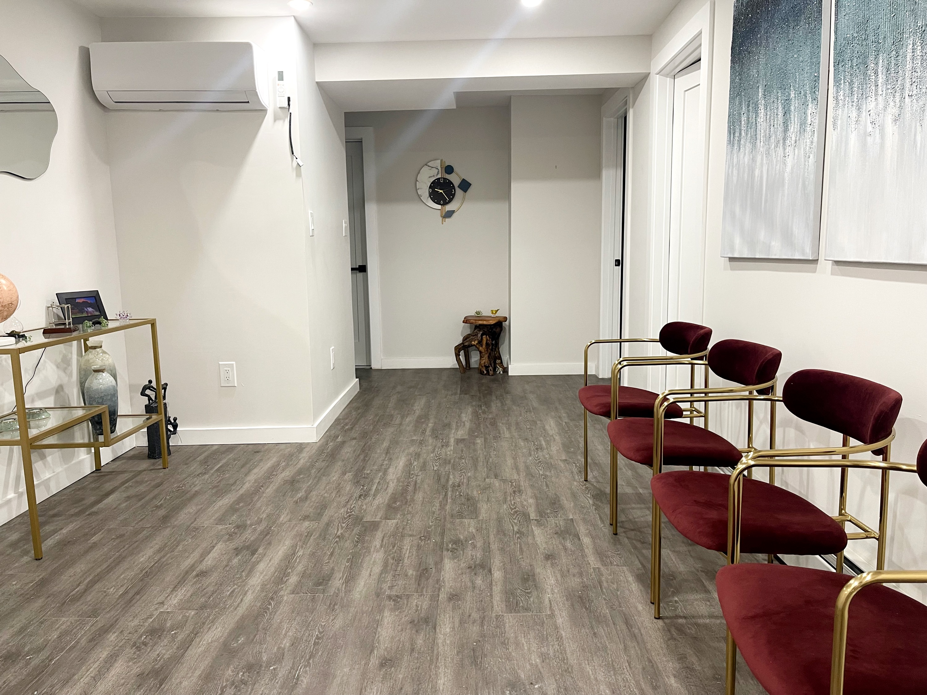 Spacious waiting room with chairs and artwork on the wall