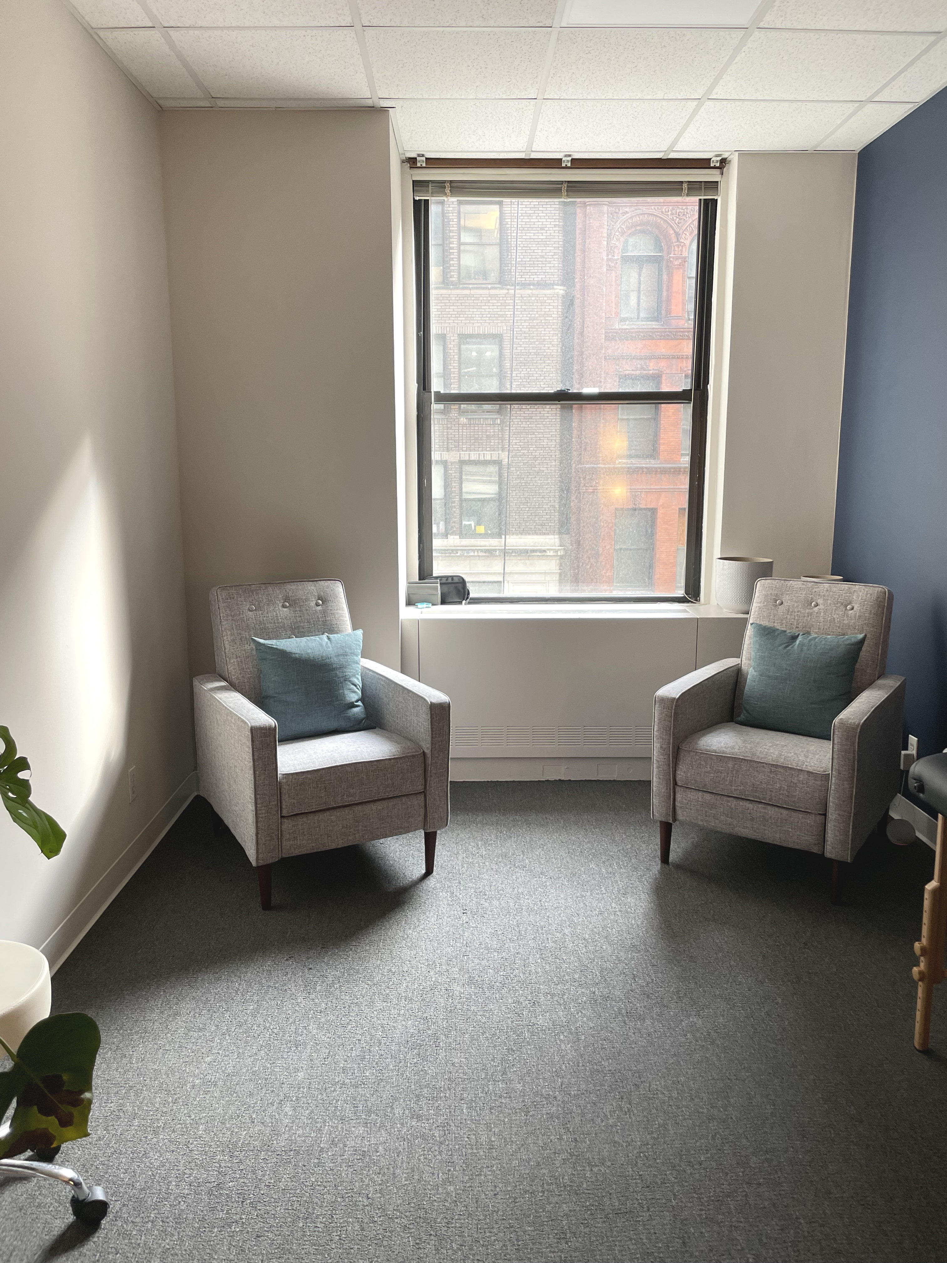 Inviting office space with couch, armchairs, and large window