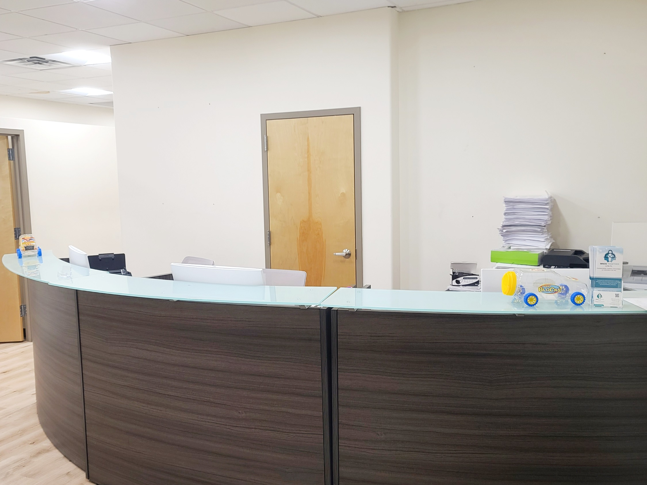 Reception area with a table, monitor, and furniture