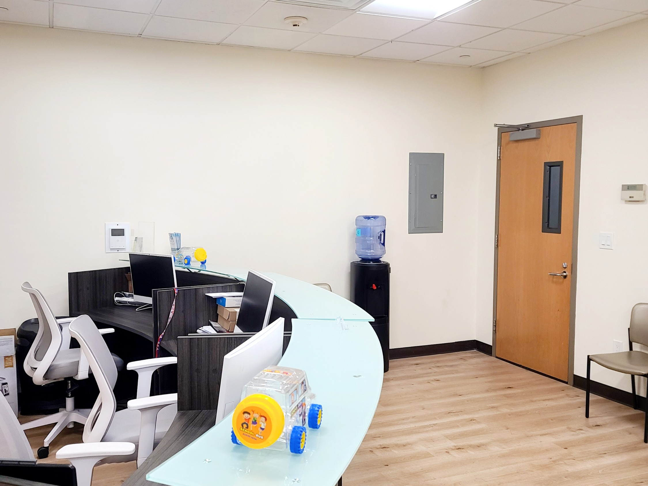 Office interior featuring desk, chair, monitor, and wood accents