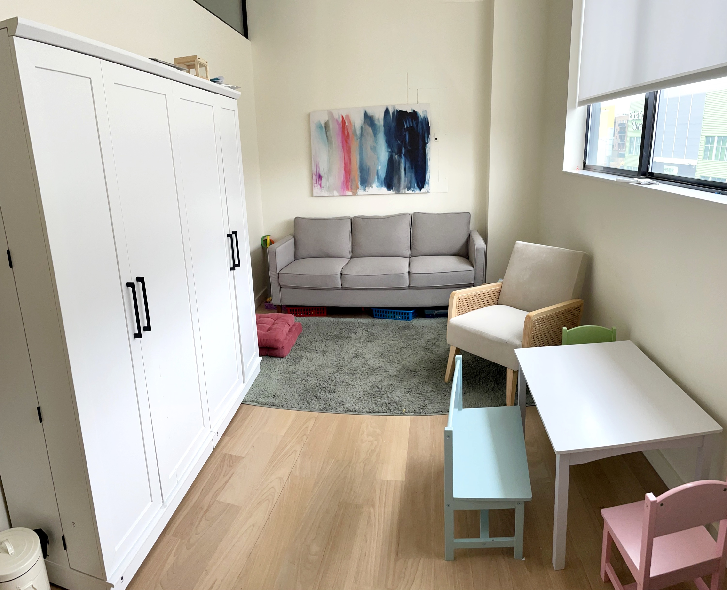 Living room style office with couch, chairs, and table