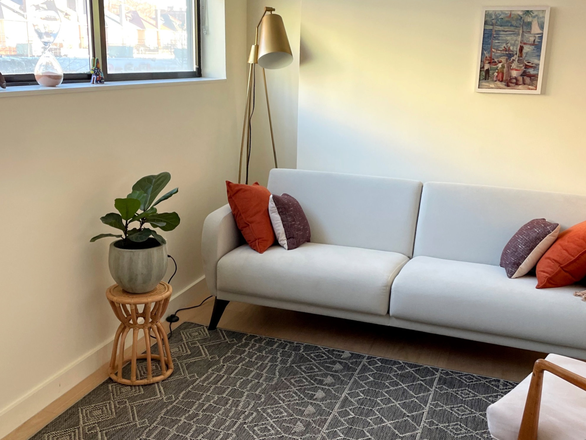 Office waiting area with couch, lamp, and plant