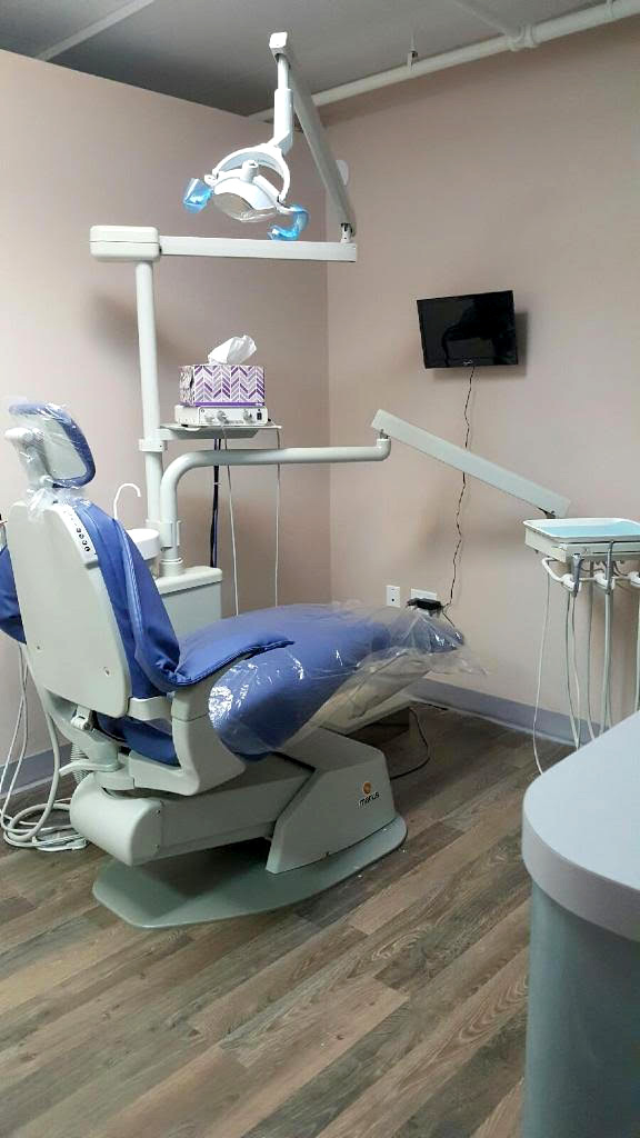 Interior view of a clinic featuring medical equipment and a monitor