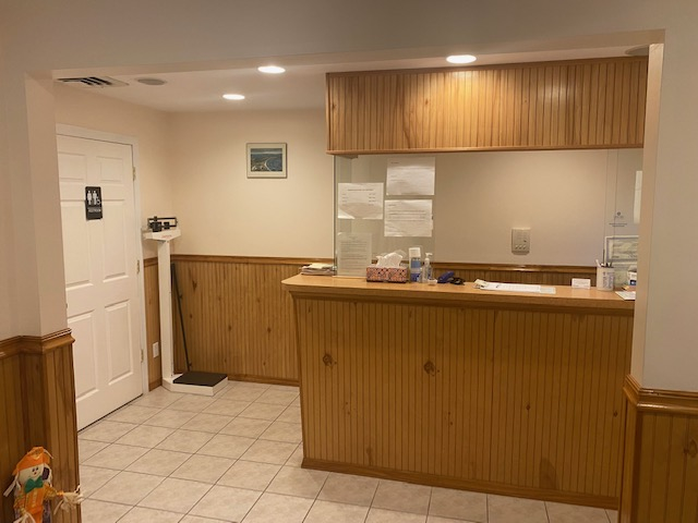 Modern kitchen area with wood paneling and art
