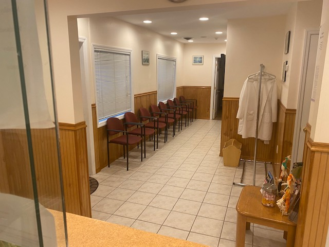 Bright office interior with desk, chairs, and artwork