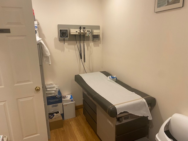 Clinic interior featuring a bed and artwork on walls