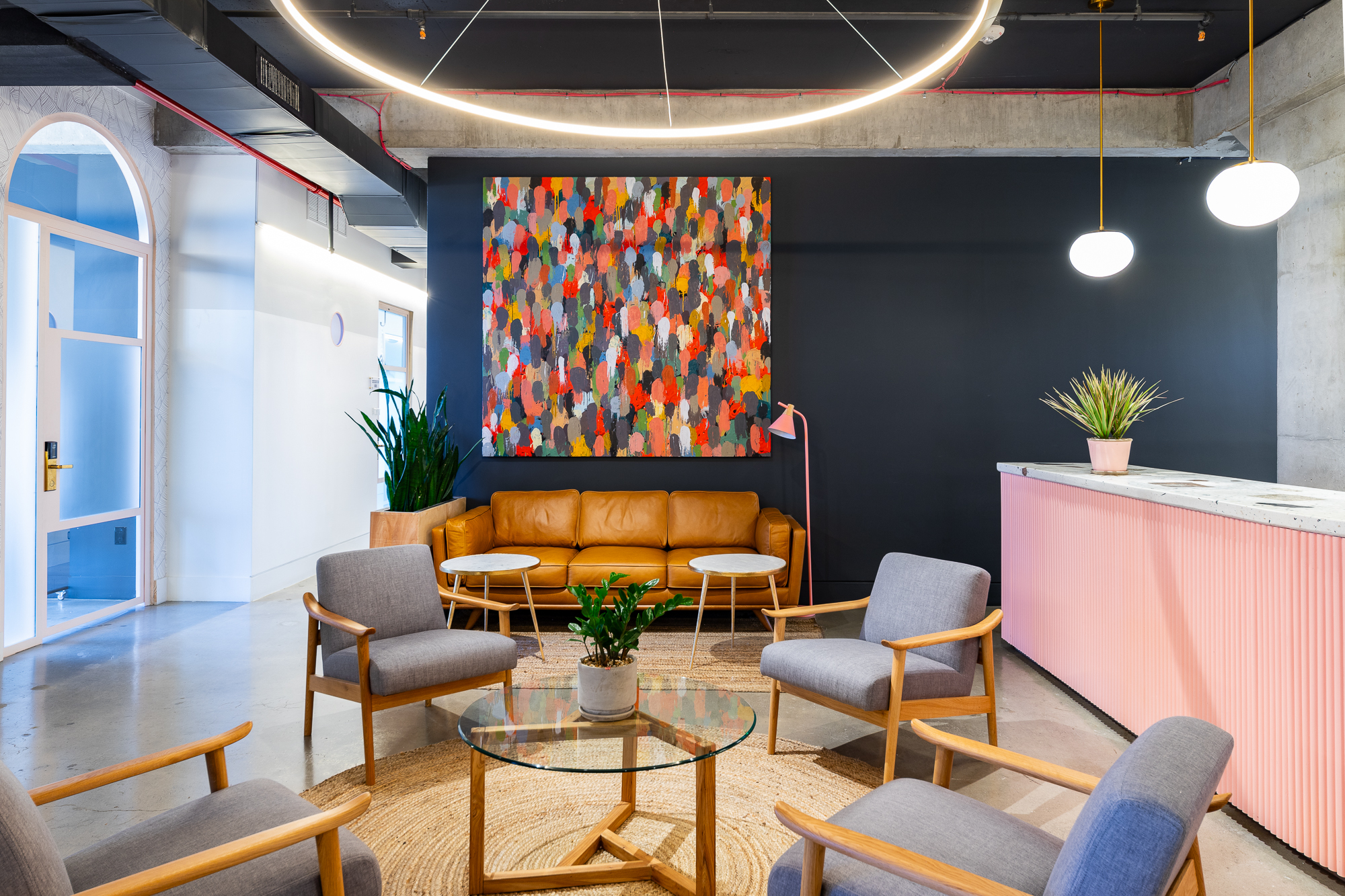 Bright foyer with a couch, chair, and lamp