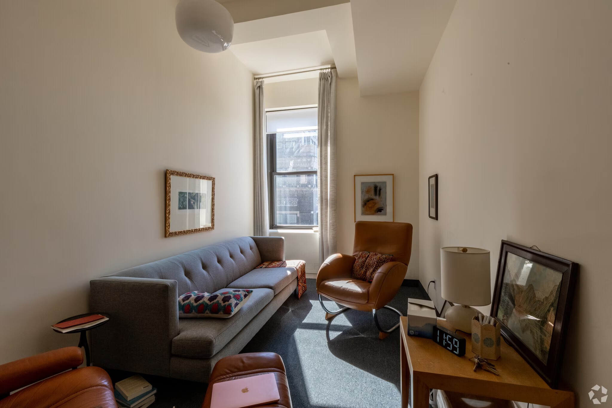 Office living room with couch and computer equipment