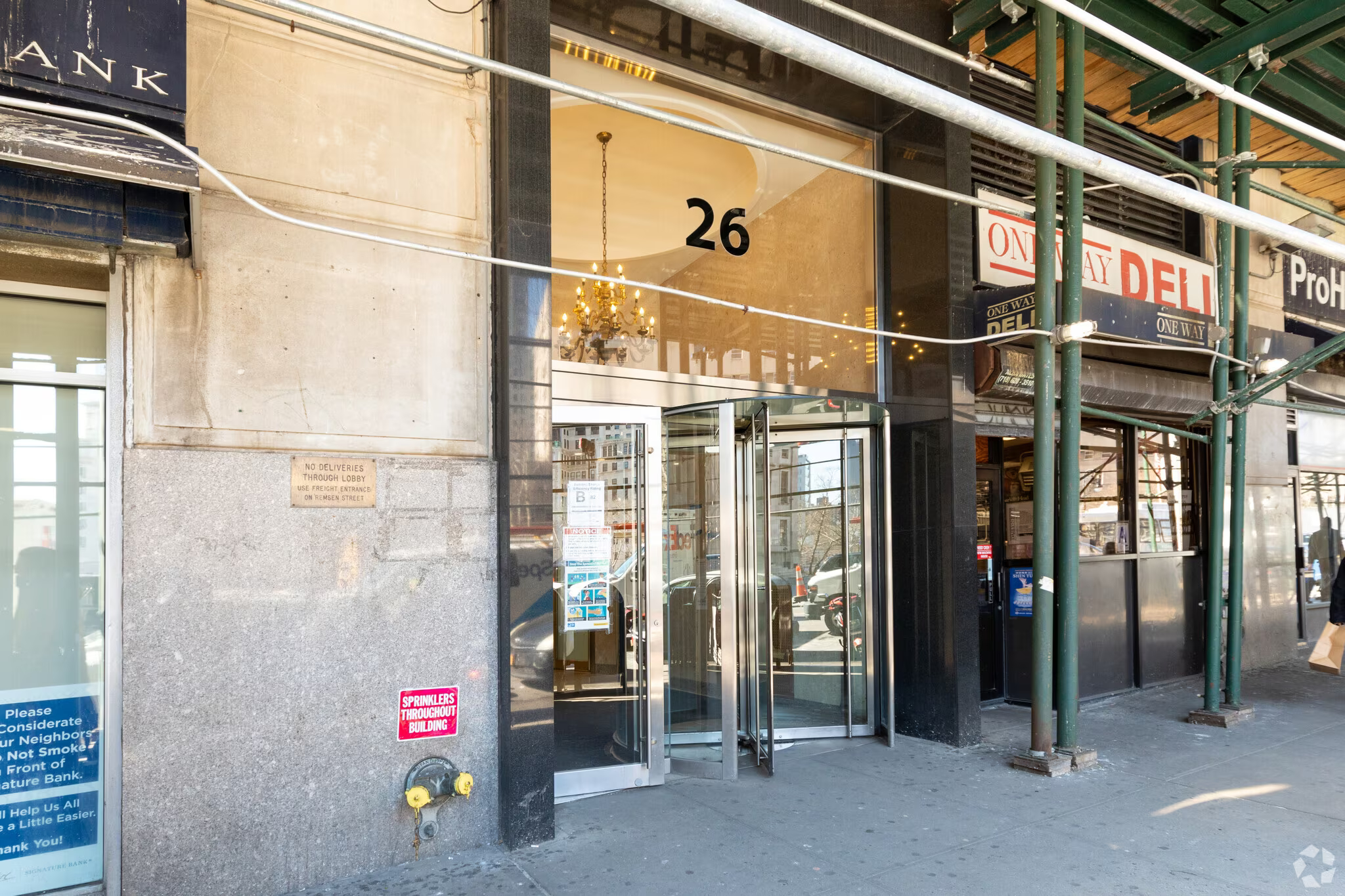 Entrance featuring revolving door and urban street view