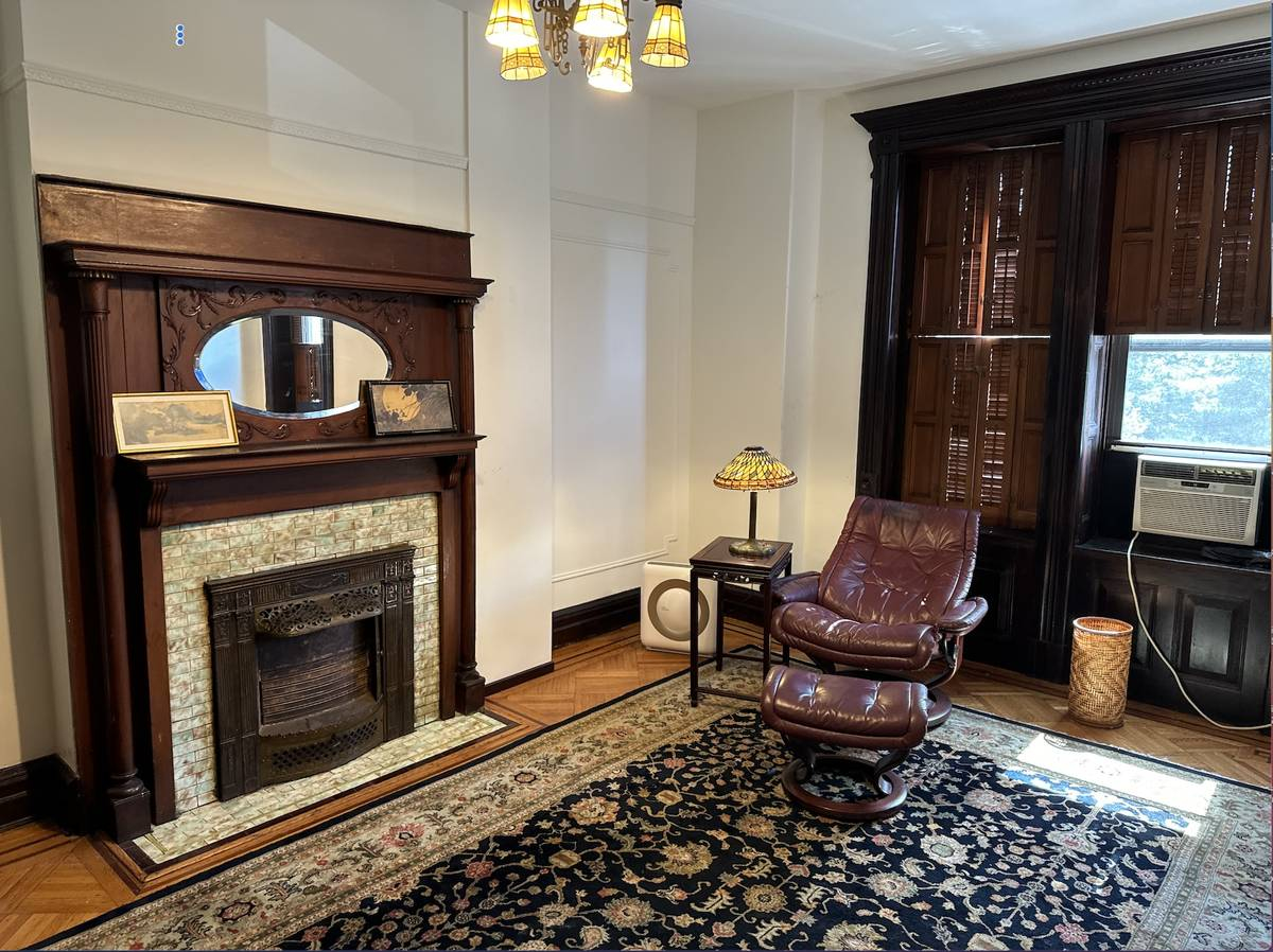 Comfortable living room area with a fireplace and chairs