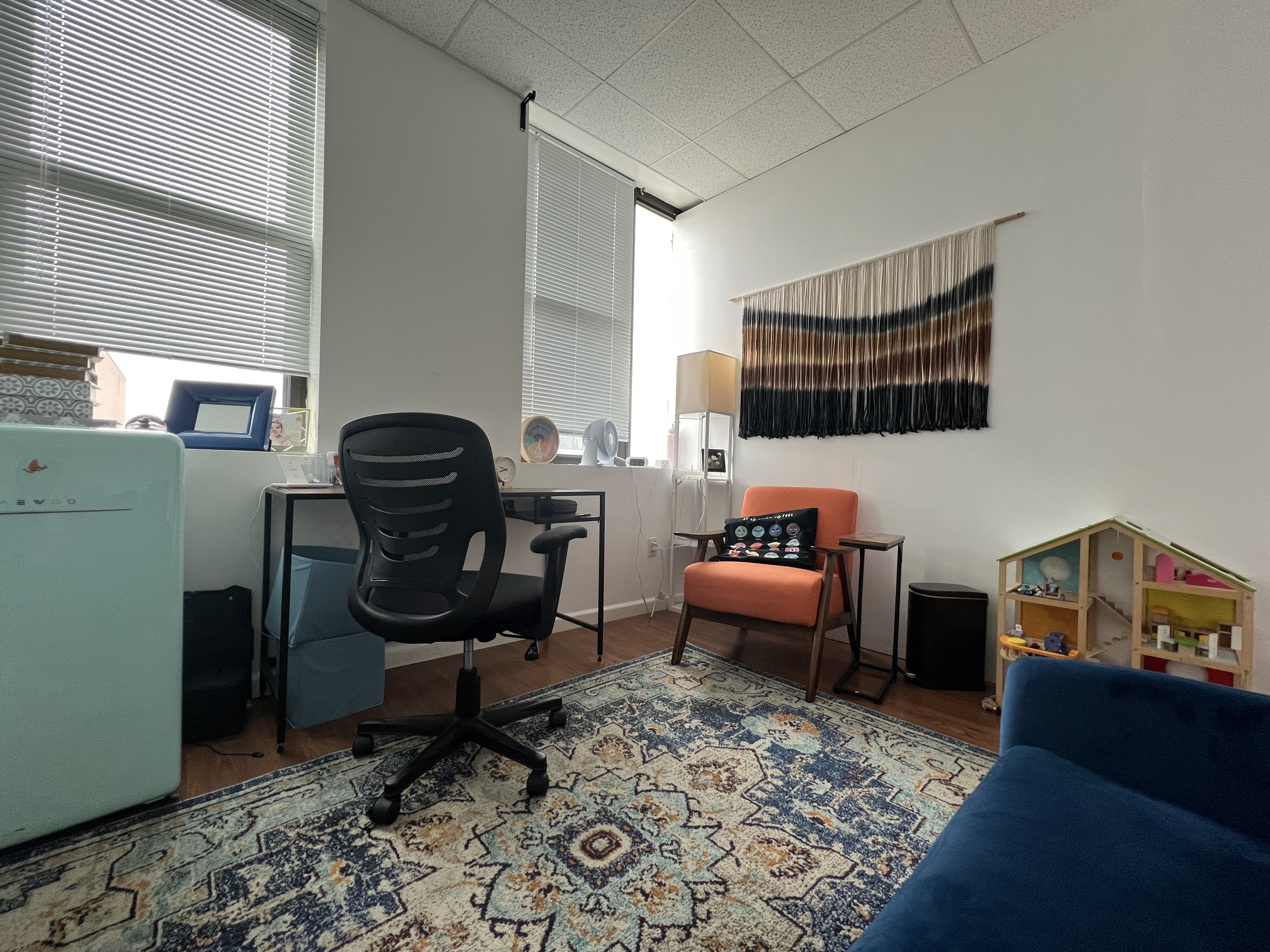 Bright office area with large windows and seating