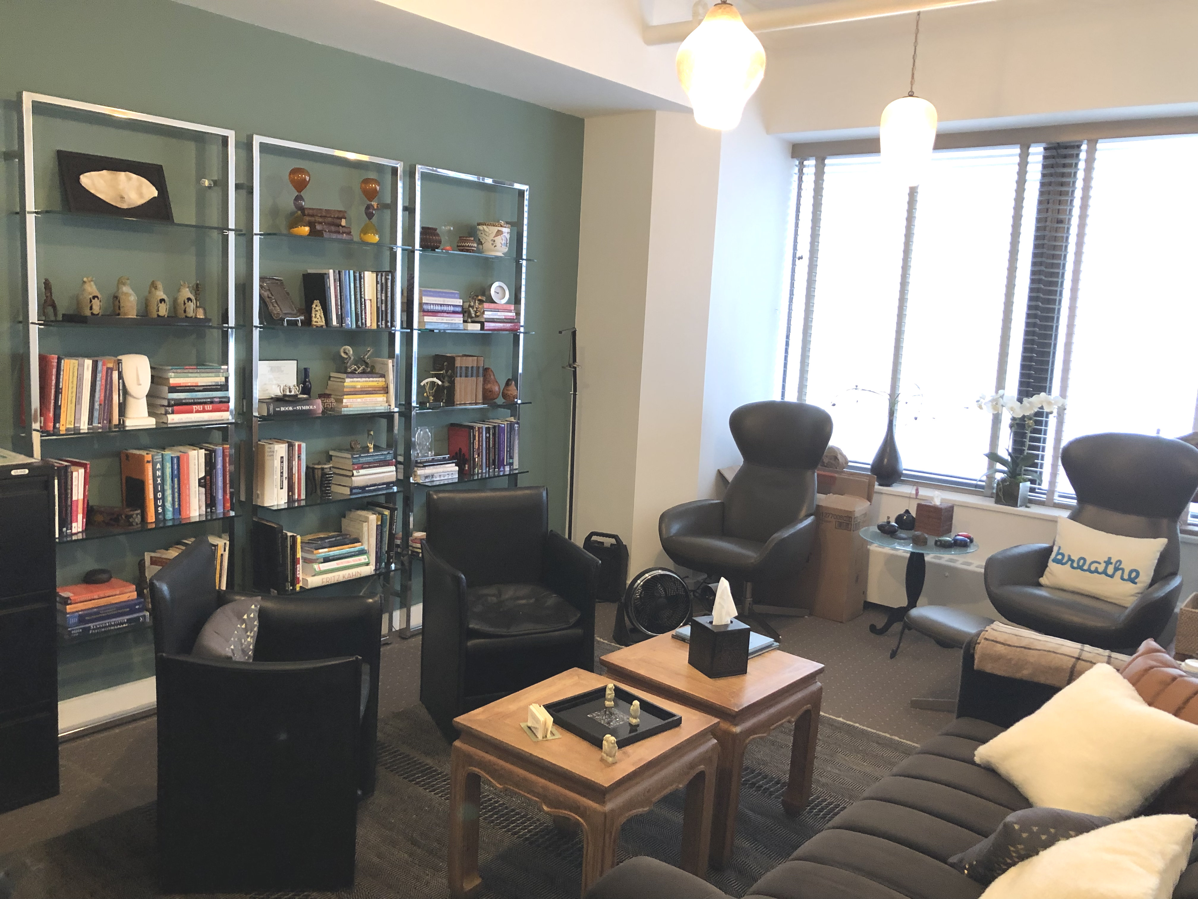 Living room styled office space with couch and desk