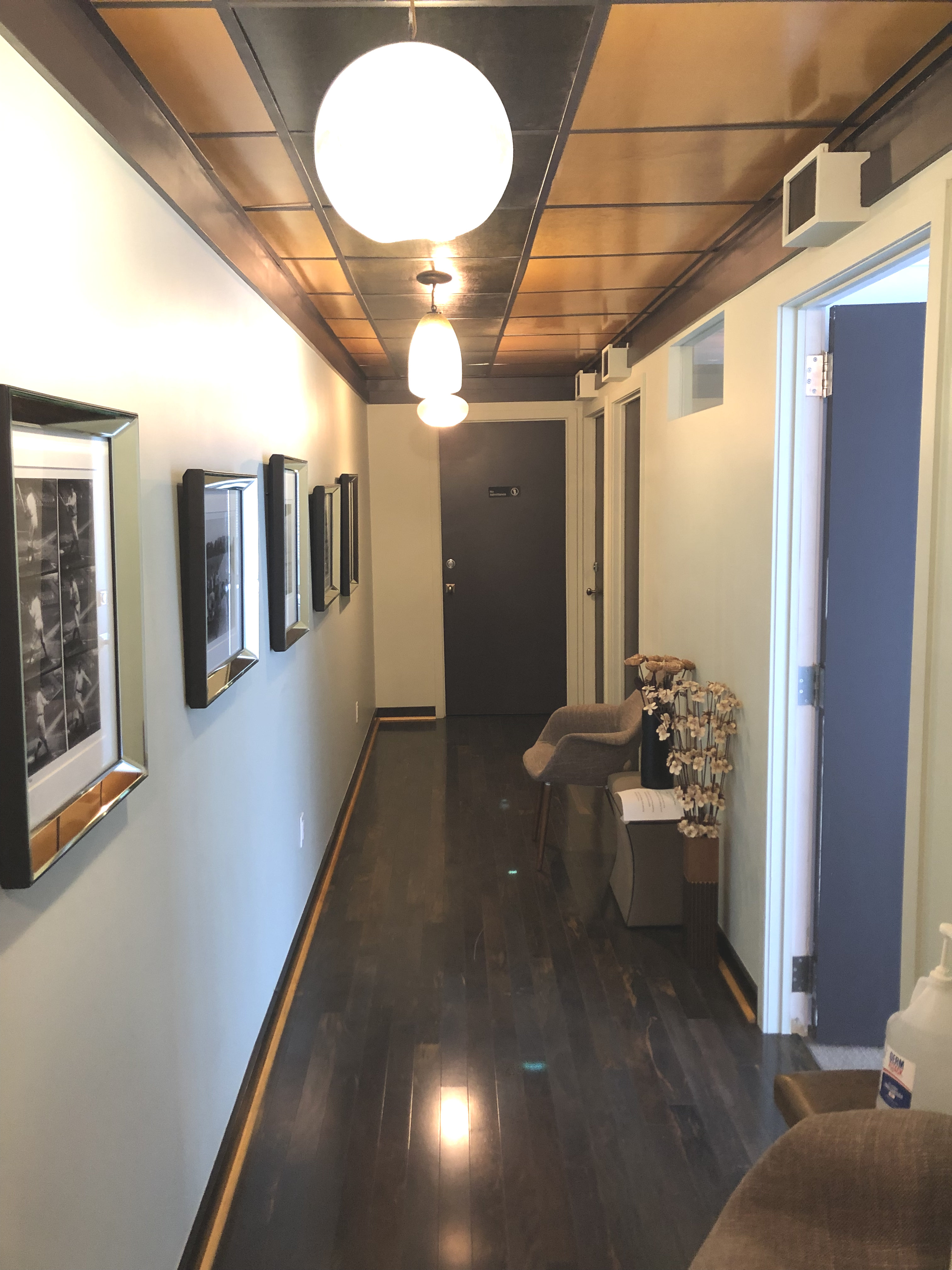 Indoor office space featuring flooring, lamps, and chairs