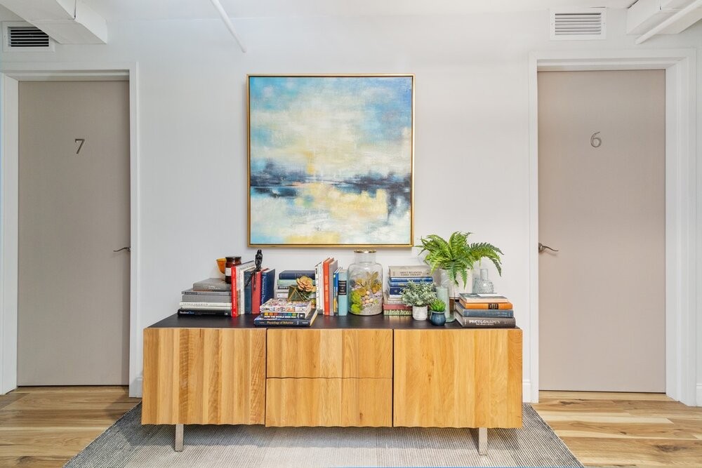 Interior office design with hardwood flooring and sideboard