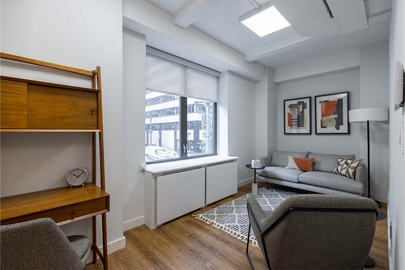 Living room area with couch, chair, and decorative elements