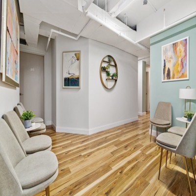 Interior office space with hardwood flooring and windows