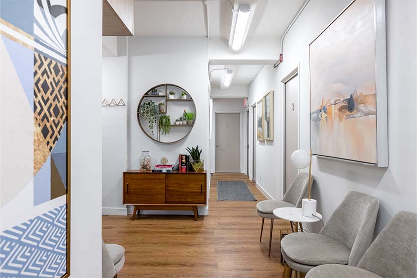 Foyer with chair, rug, and potted plant