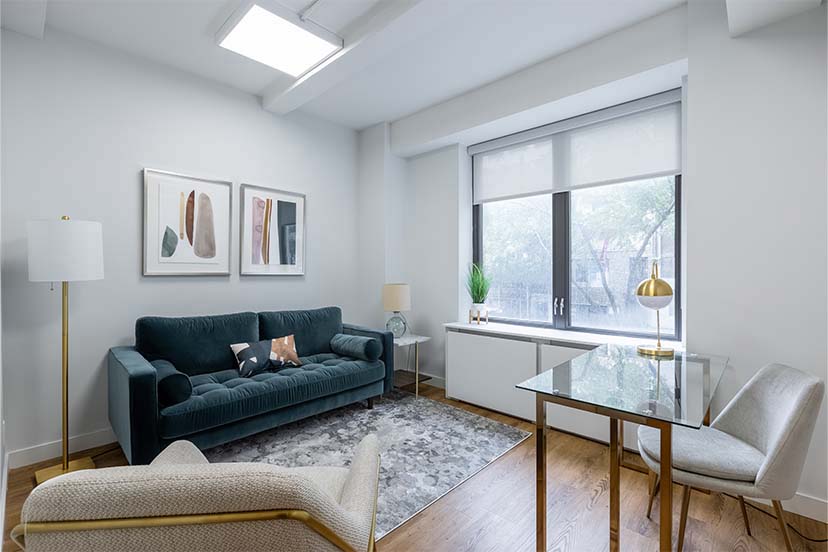 Living room setup with couch, chairs, and decor elements