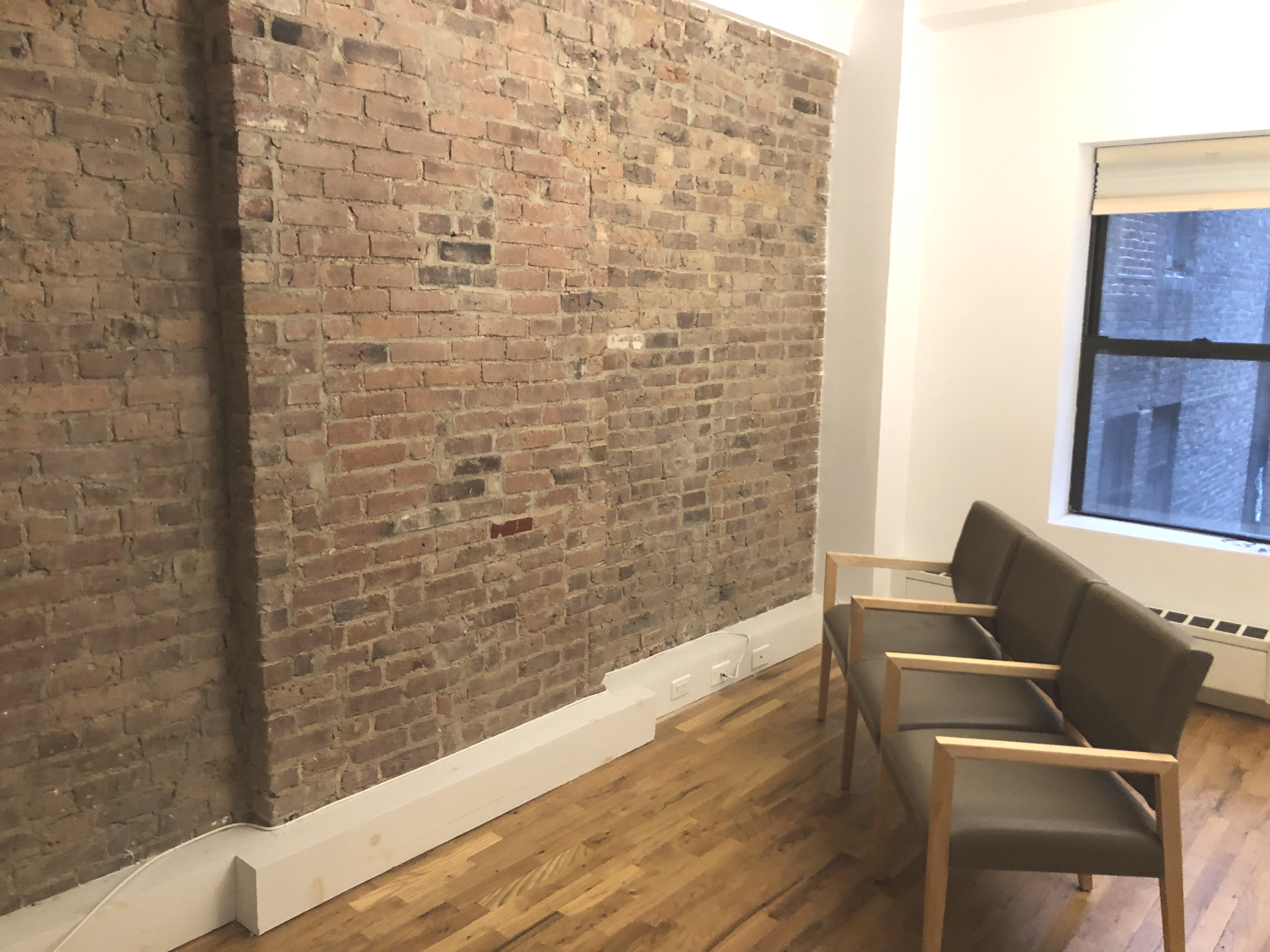 Interior office space with wooden paneling and chairs