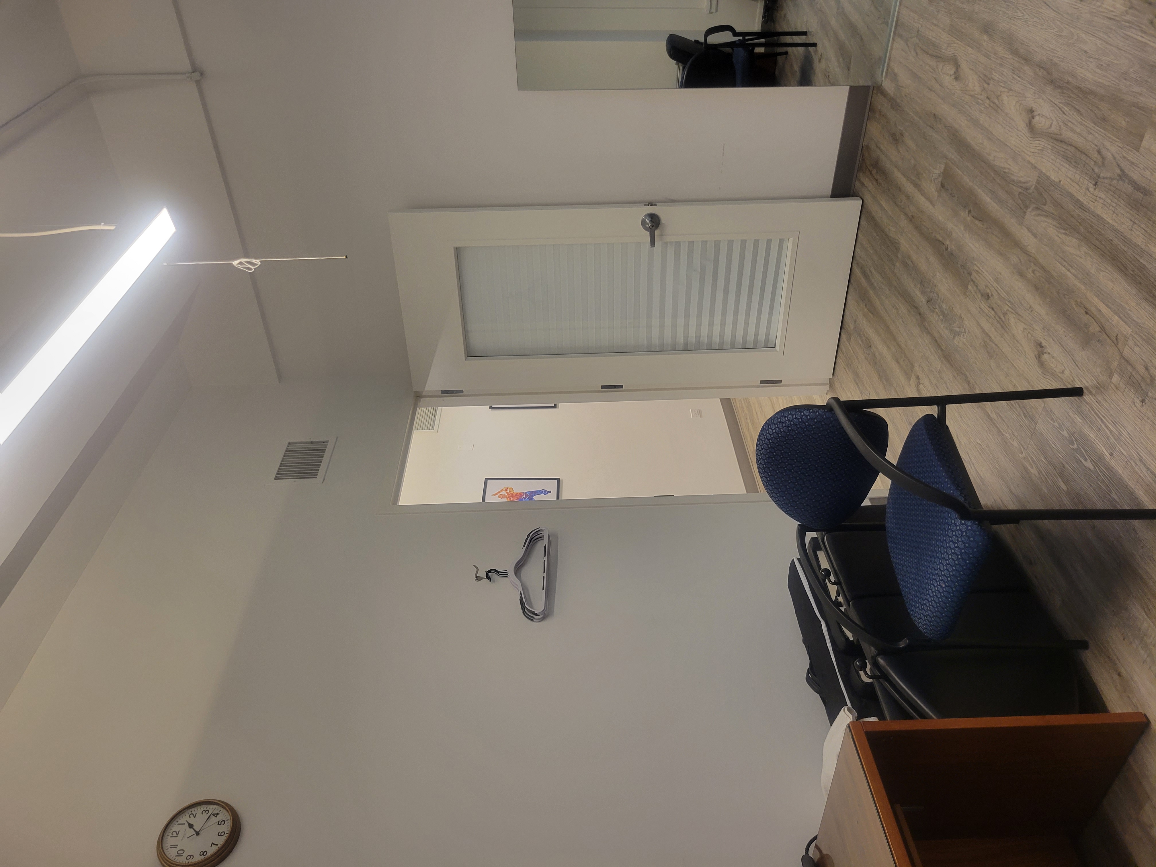 Office interior featuring desk, chair, and lamp