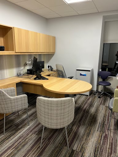 Office setup with desk, chairs, and monitor