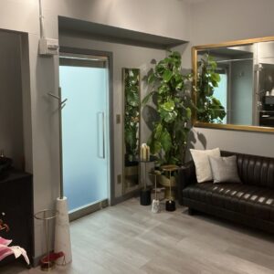 Interior space with couch, plants, and sliding door