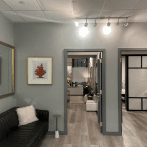 Bright office room with couch and door leading to foyer