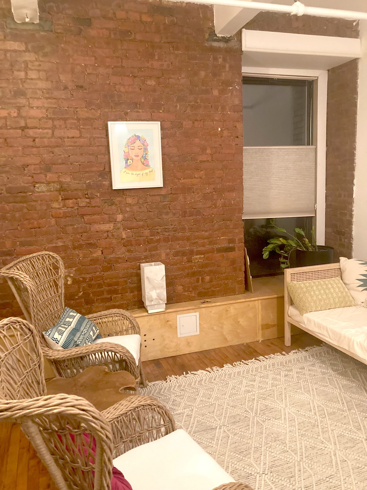 Living room area with couch, chair, and decorative rug