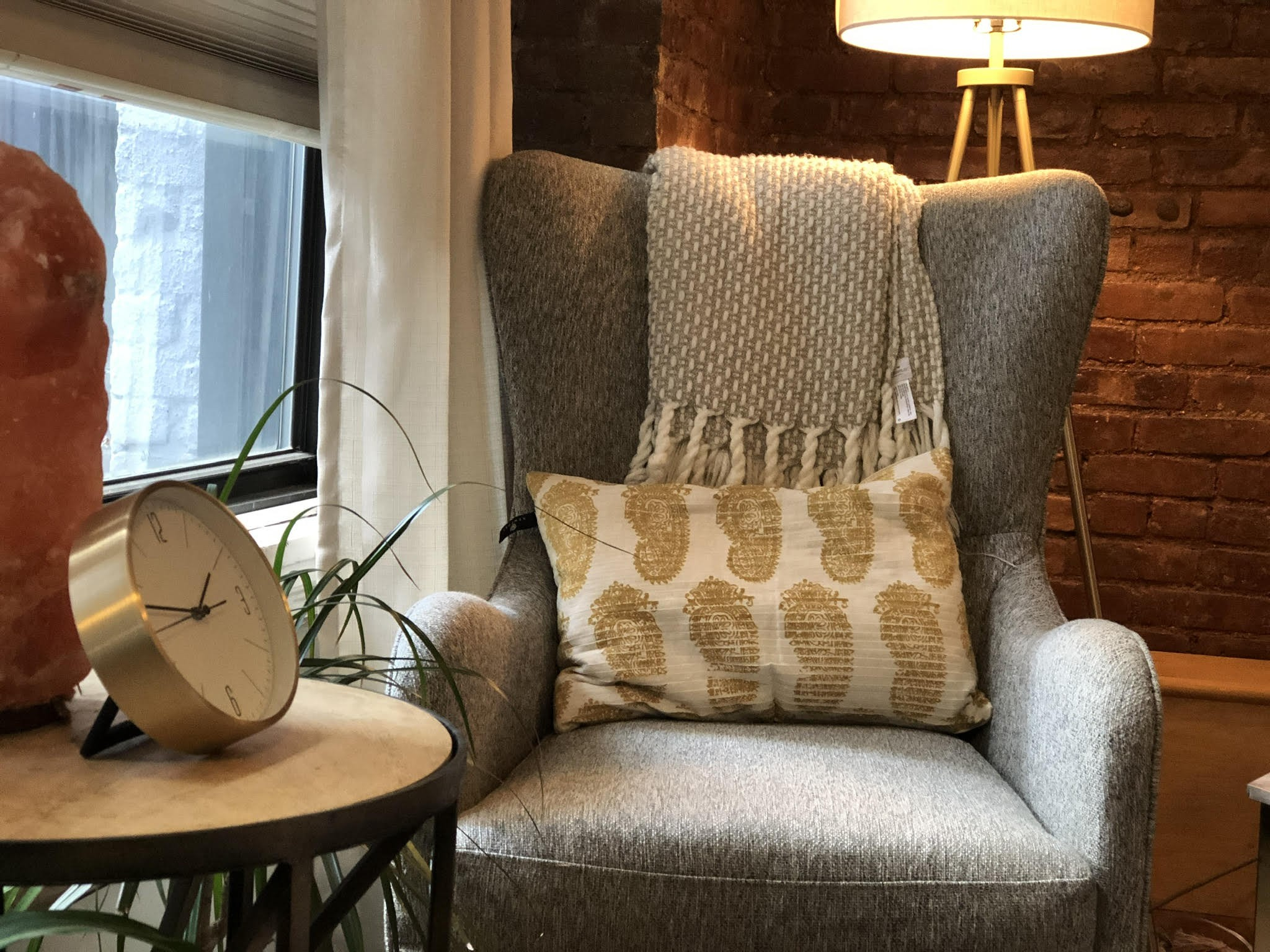 Comfortable seating area with couch, armchair, and lamp