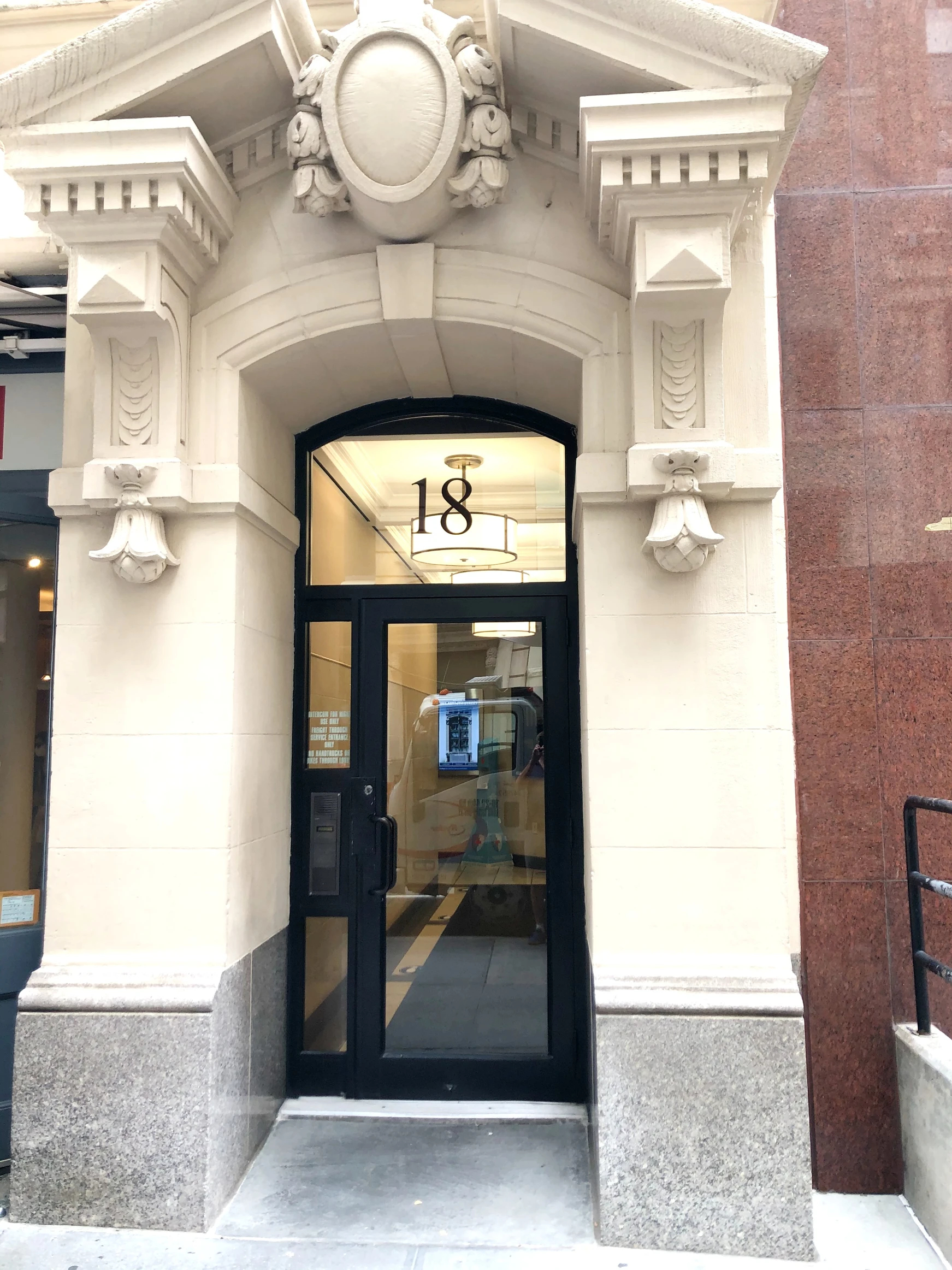 Entrance of a building with a decorative arch and lamp