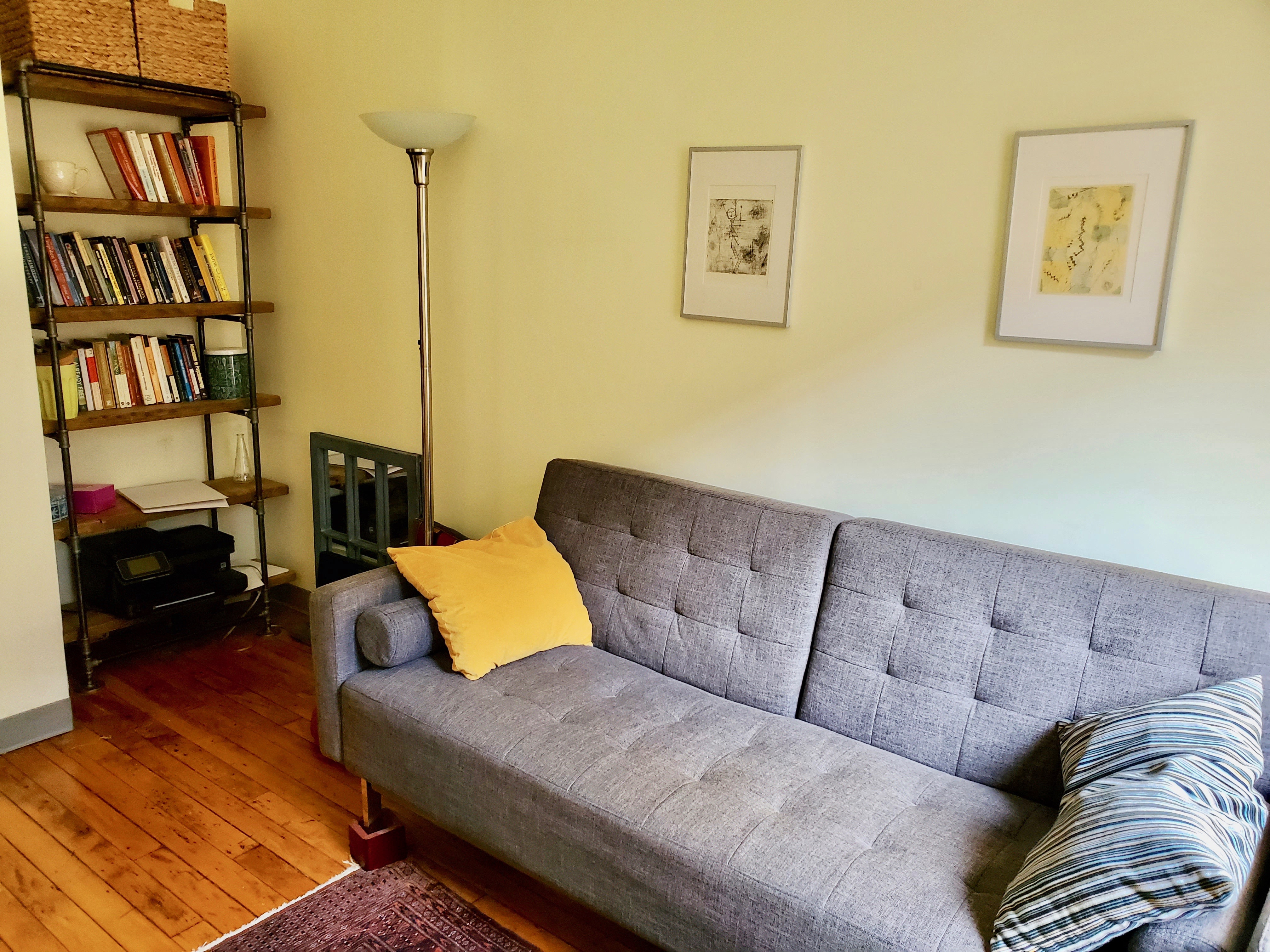 Brightly lit office area with multiple desks and chairs