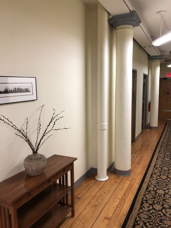 Interior office space with hardwood flooring and plants
