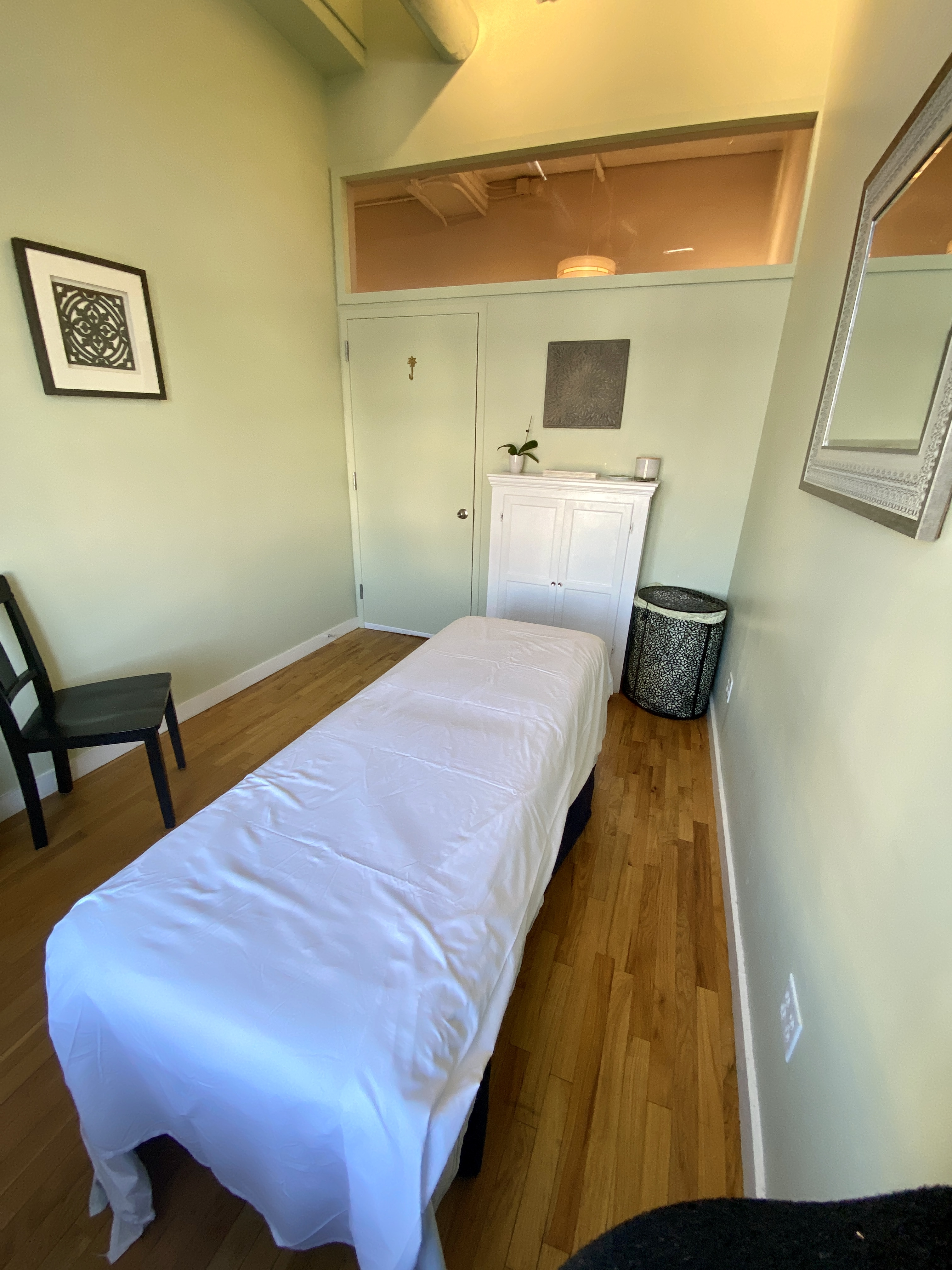 Private clinic room with hardwood flooring and plant decor