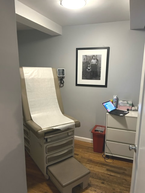 Clinic office featuring a desk, computer, and photo frame