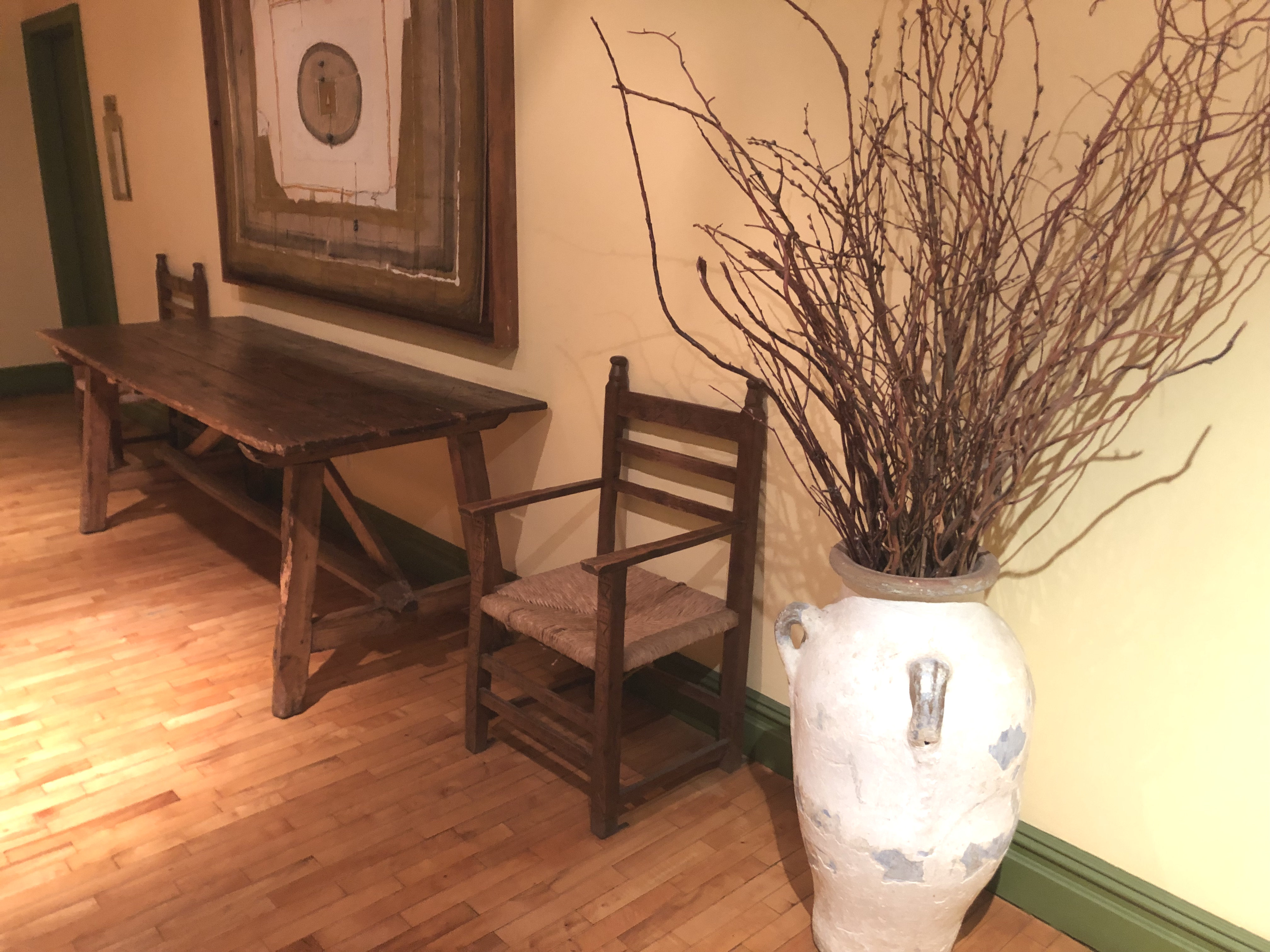 Office space featuring hardwood flooring, desk, and seating