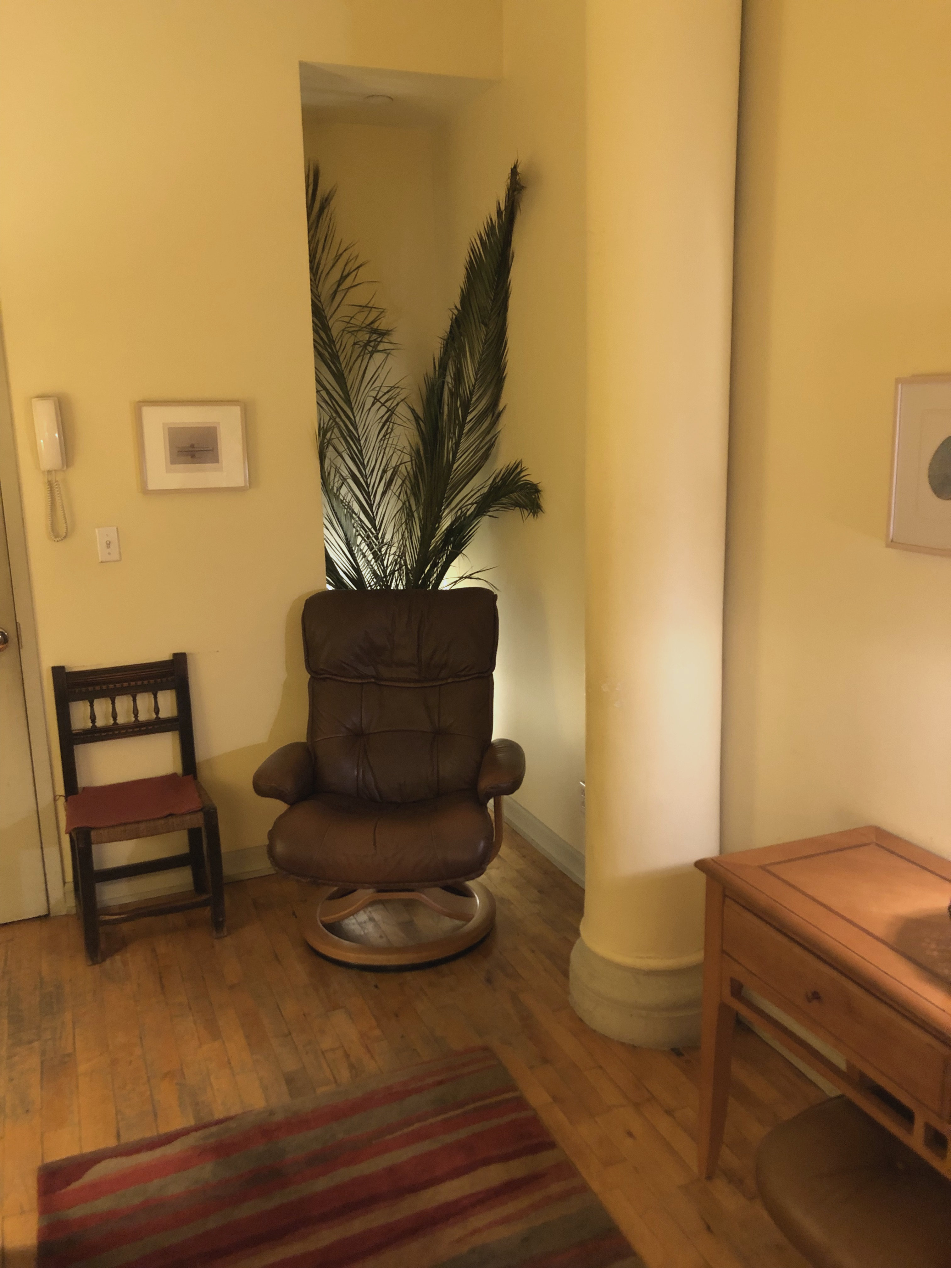 Office space featuring hardwood flooring and furniture setup