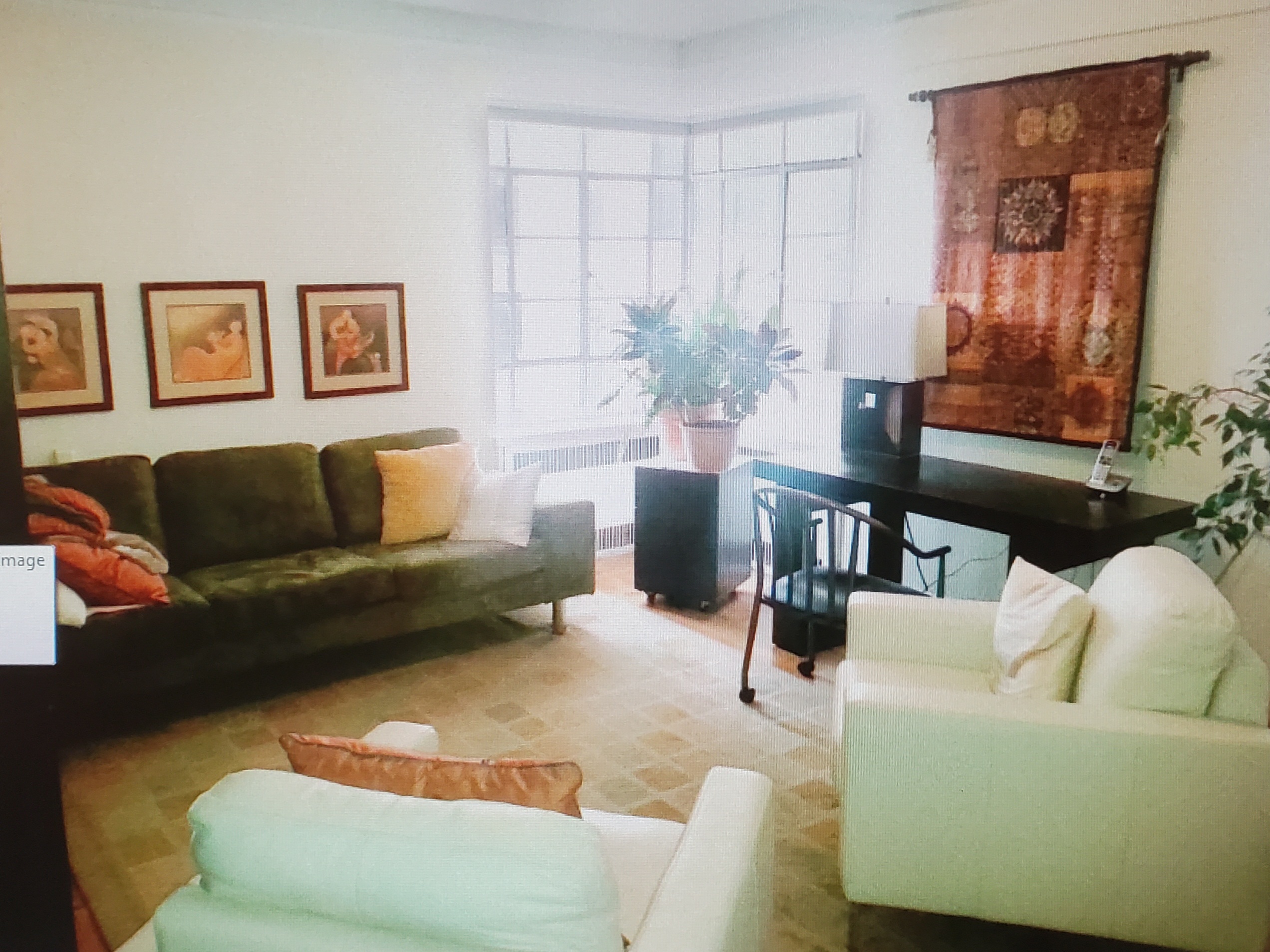 Living room style office with seating and decor