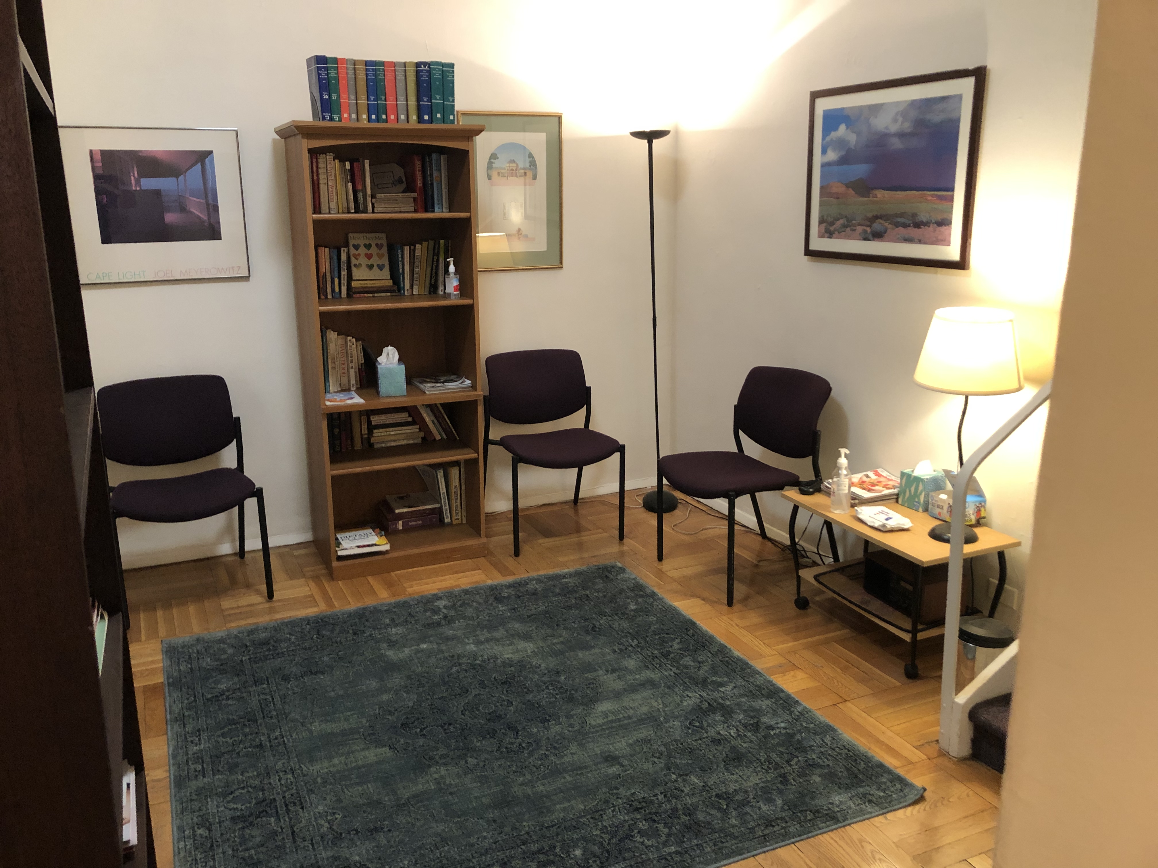 Living room styled office with rug, lamp, and chair