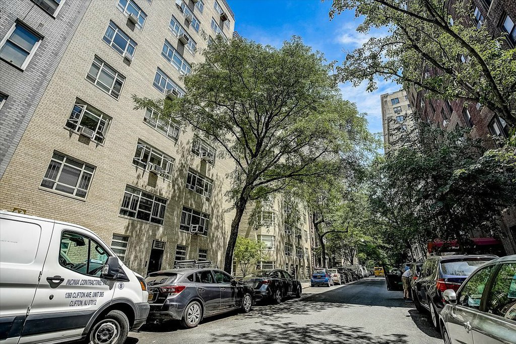 Urban office building surrounded by vehicles and cityscape