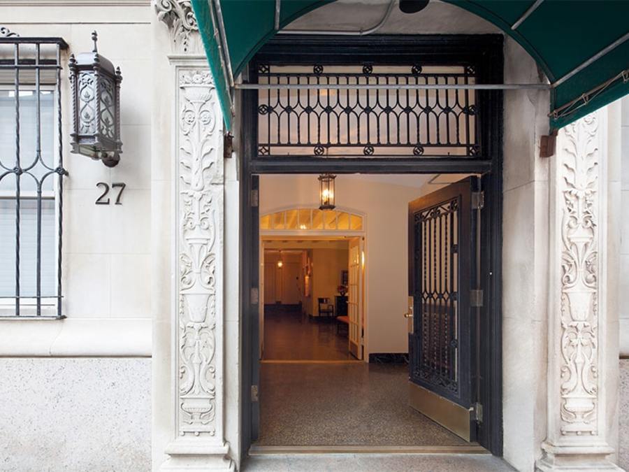 Bright foyer with elegant flooring and entrance gate