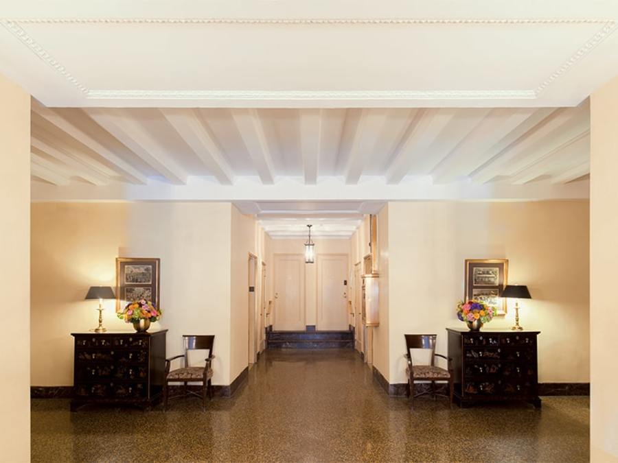 Foyer with chairs, art on walls, and contemporary lighting