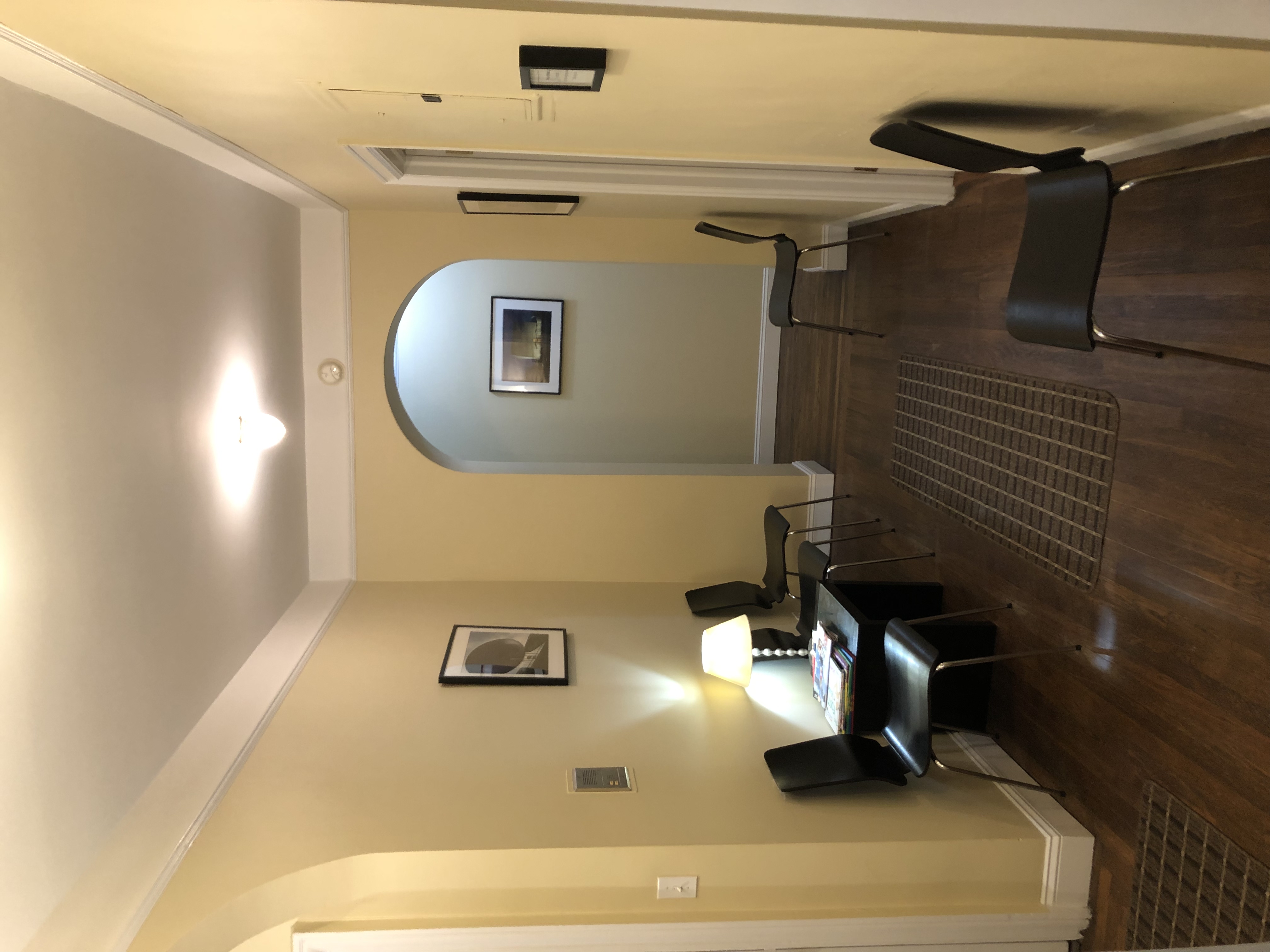 Living room-style office with couch, chair, and lamp