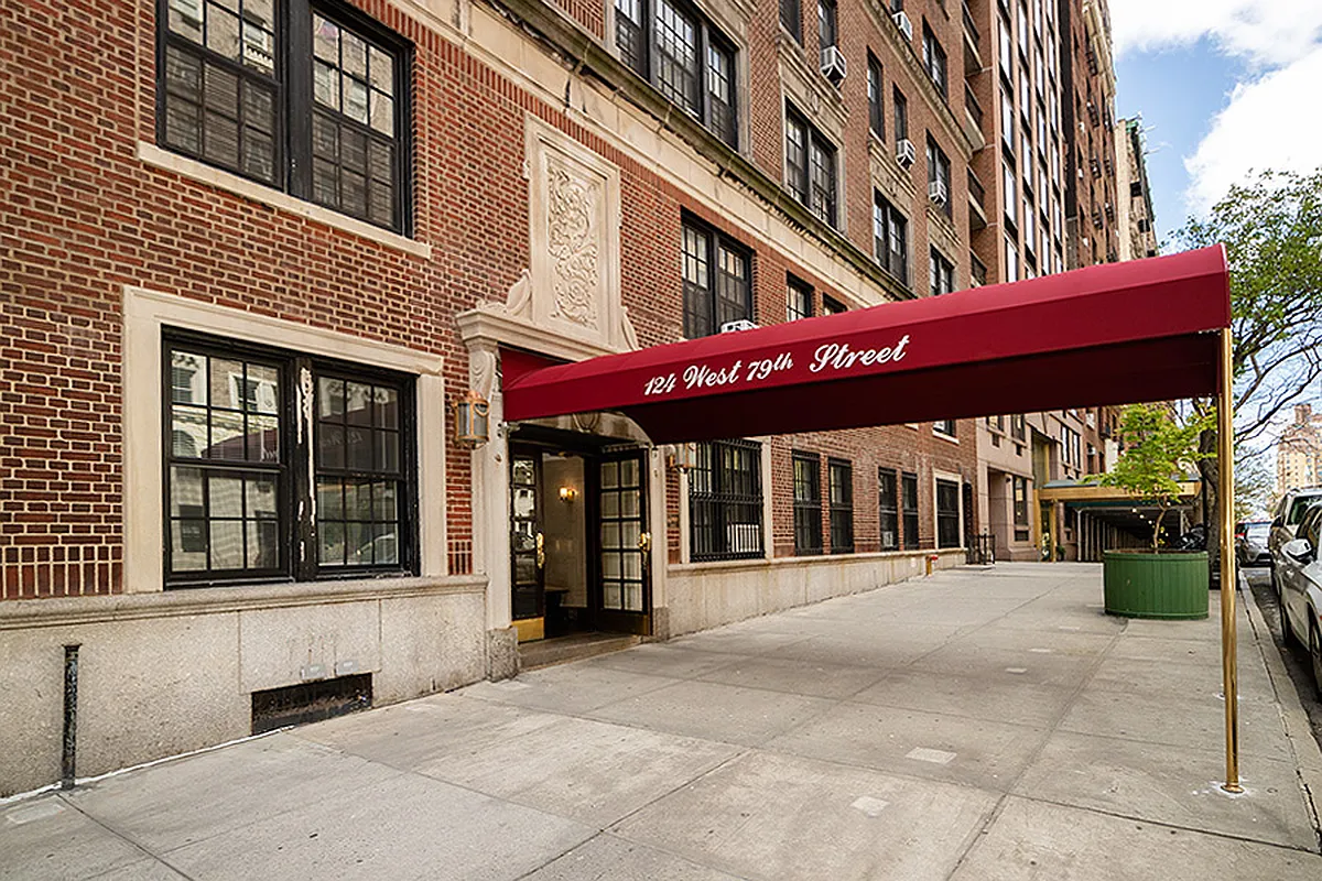 Office corridor with carpeted flooring and doors