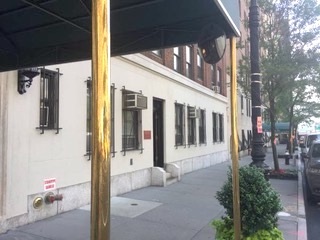 Street view of urban office building with vehicles