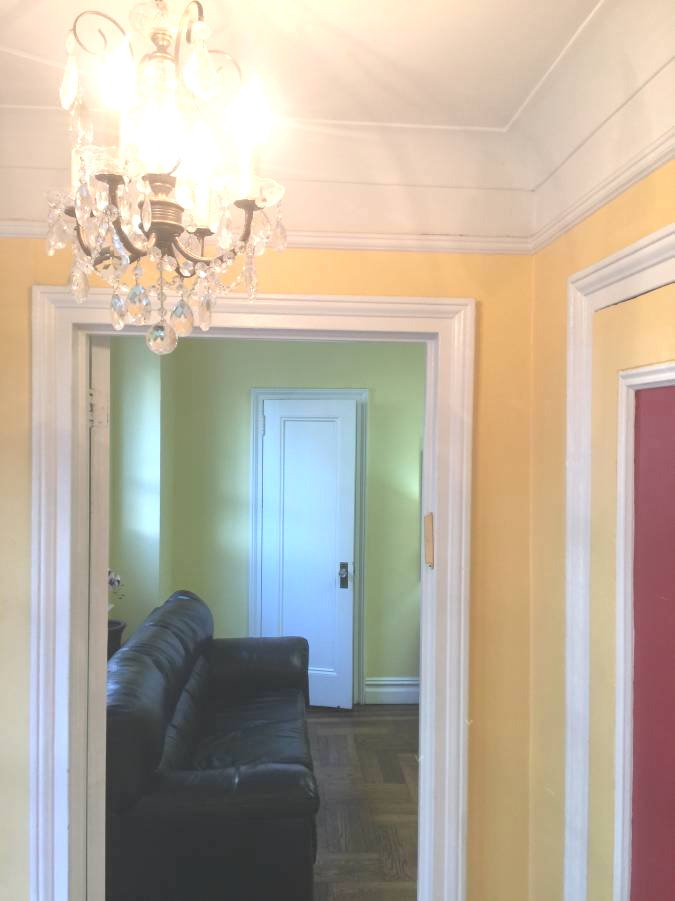 Foyer with elegant chandelier and comfortable couch seating
