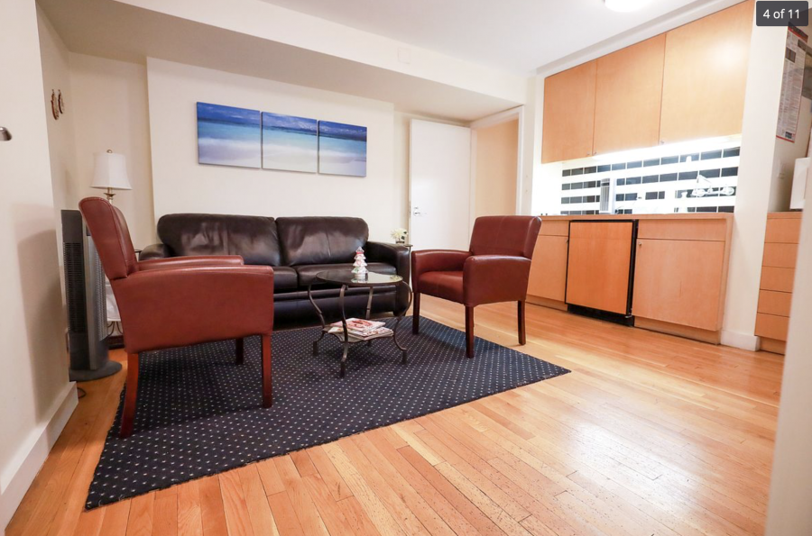 Living room with couch, table, and area rug