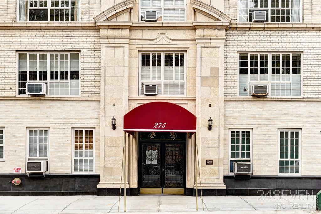 Office building exterior featuring large windows and doors