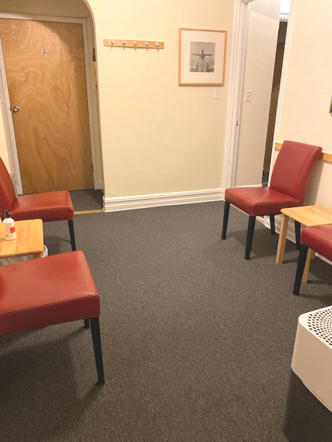 Waiting room featuring chairs and a dining table
